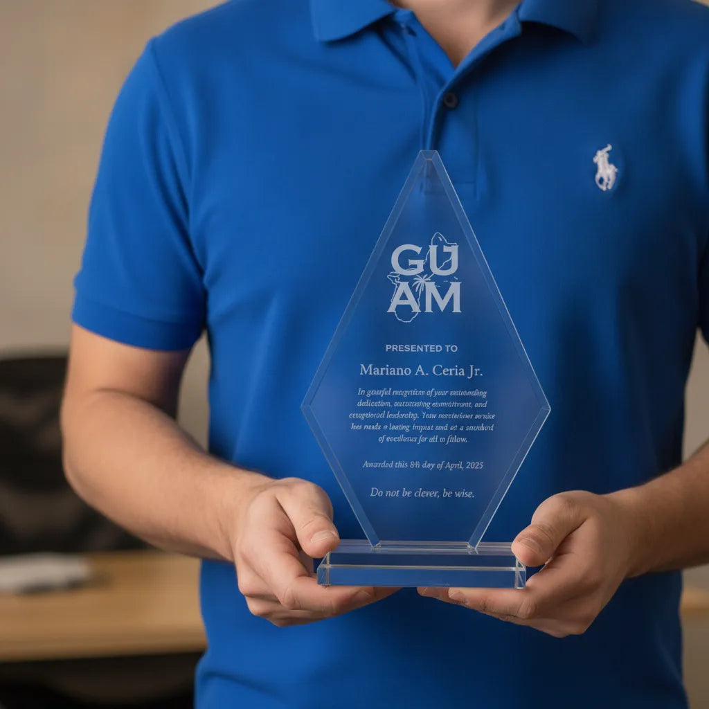 Person holding a custom engraved diamond crystal award plaque with blue base, featuring personalized recognition text and logo, showcased in a professional office setting with soft natural lighting.