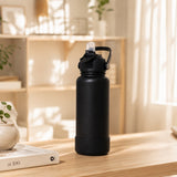 Black 32oz stainless steel water bottle with flip straw cap and protective silicone bottom boot