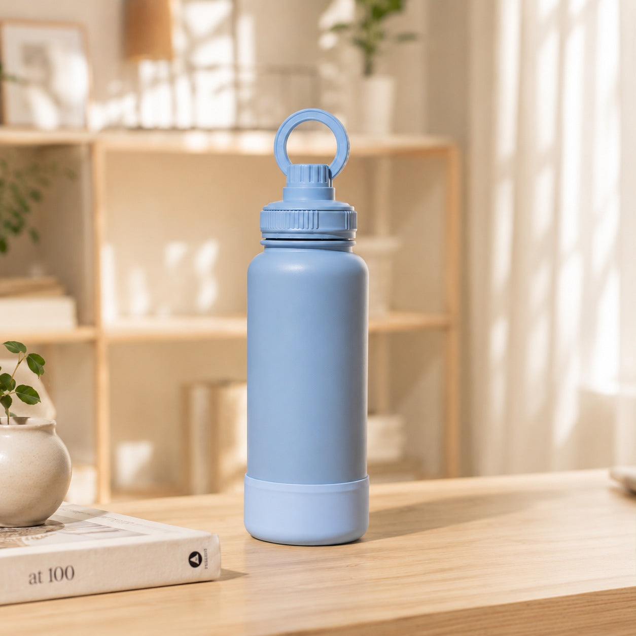 Blue 32oz powder-coated stainless steel flask featuring a magnetic phone-holding handle and protective rubber boot