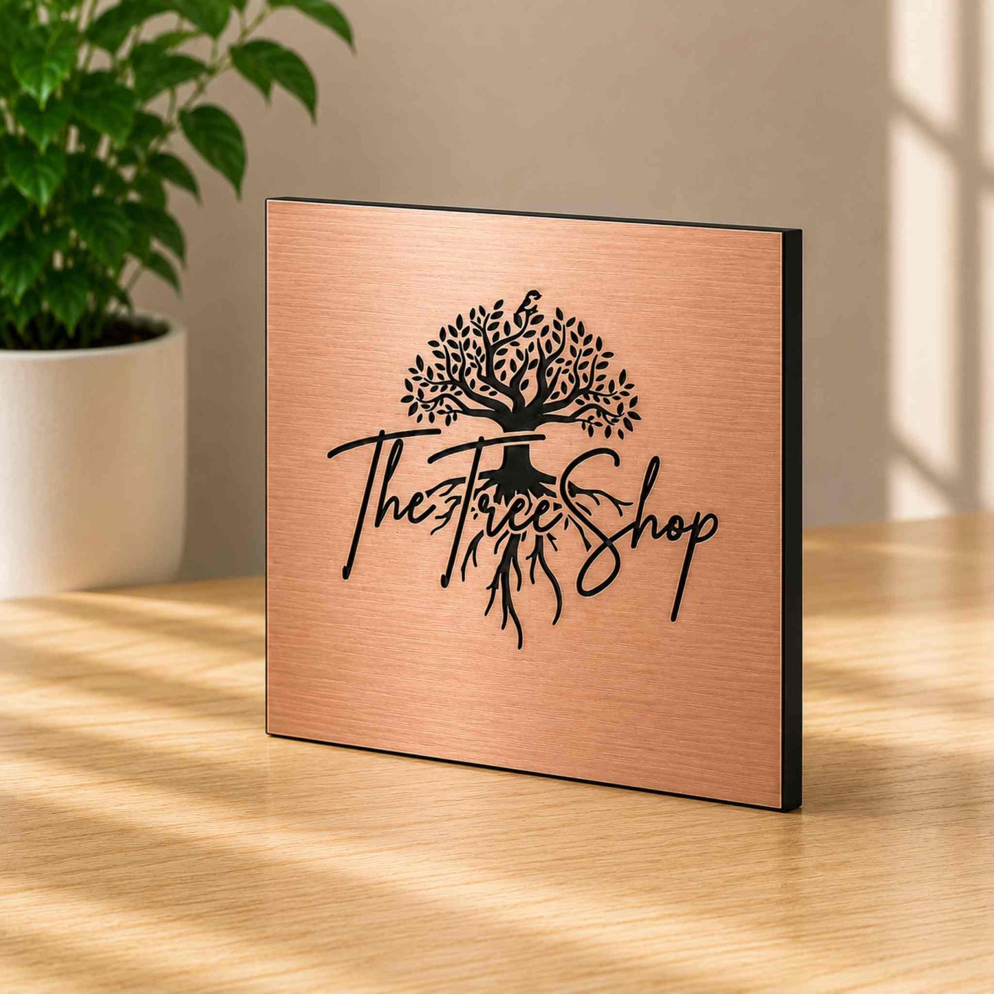 Brushed bronze metal plaque with engraved logo in bright Scandinavian-inspired interior
