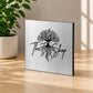 Brushed silver metal plaque with engraved logo on light oak table in premium lifestyle setting