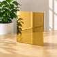 Polished gold mirror metal plaque reflecting natural light in luxury tabletop display
