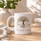 White mug with 'Tree Shop' design on a wooden surface with a plant in the background
