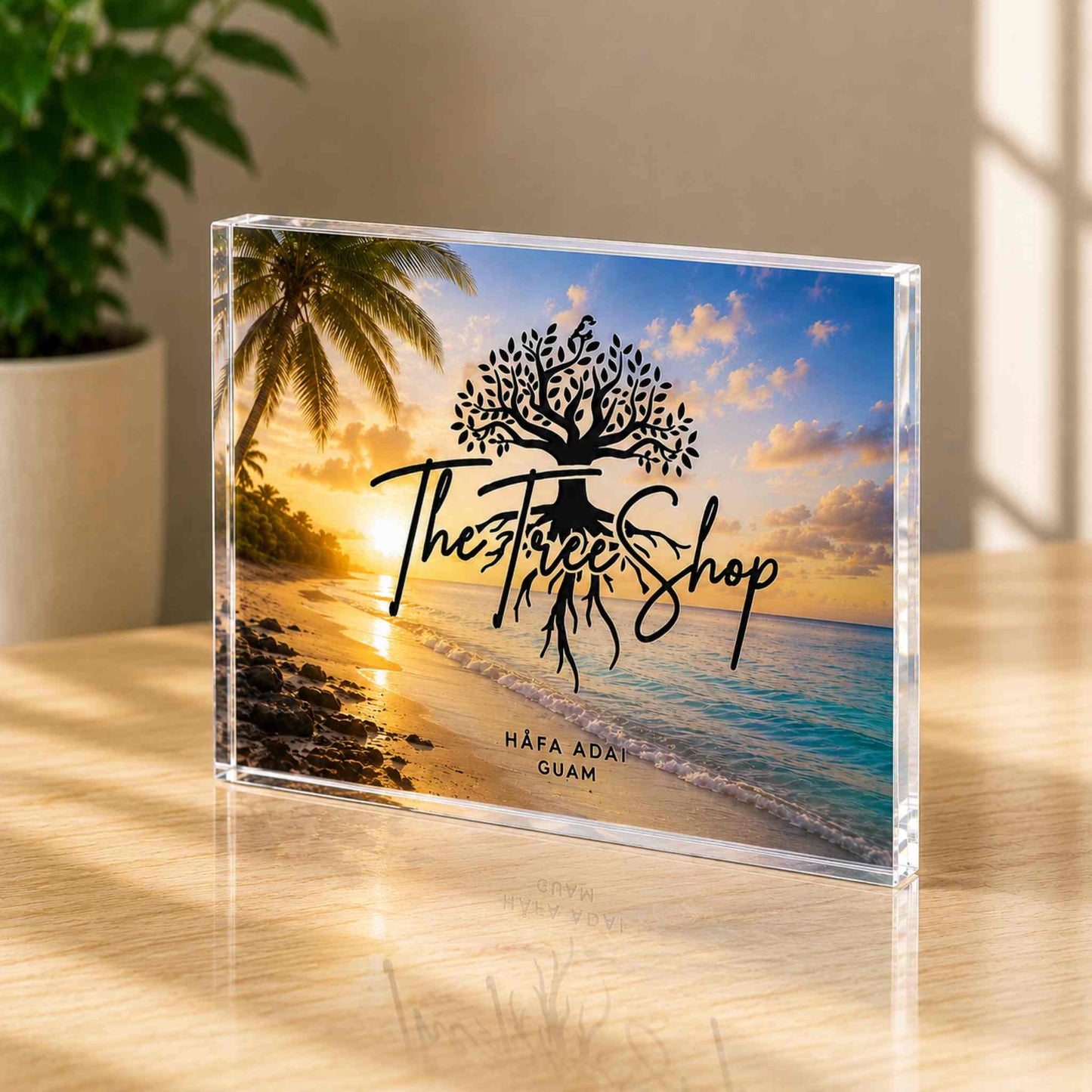 Clear acrylic block with 'The Tree Shop' logo and beach scene on a wooden surface.