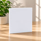 Blank white acrylic panel for custom signage displayed on light oak tabletop