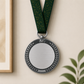 Silver medal with a dark silver laurel wreath border and dark green neck ribbon.