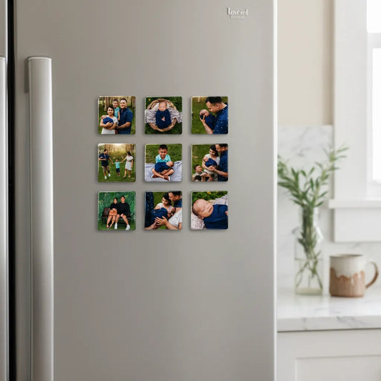 A neat three-by-three grid layout of nine large 2.5 inch personalized square glossy family photo magnets mounted on a clean white refrigerator door next to a small kitchen countertop vase.