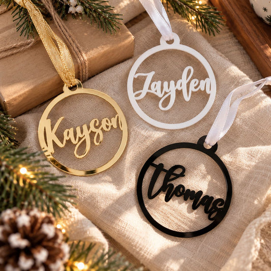 Personalized Christmas ornaments with custom names in gold, white, and black, perfect for family Christmas tree decorations.