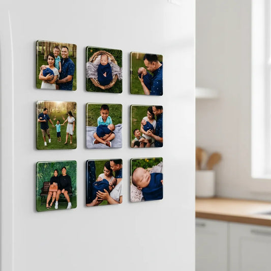 A neat three-by-three grid layout of nine custom square glossy family photo magnets mounted on a clean white refrigerator door inside a bright kitchen.