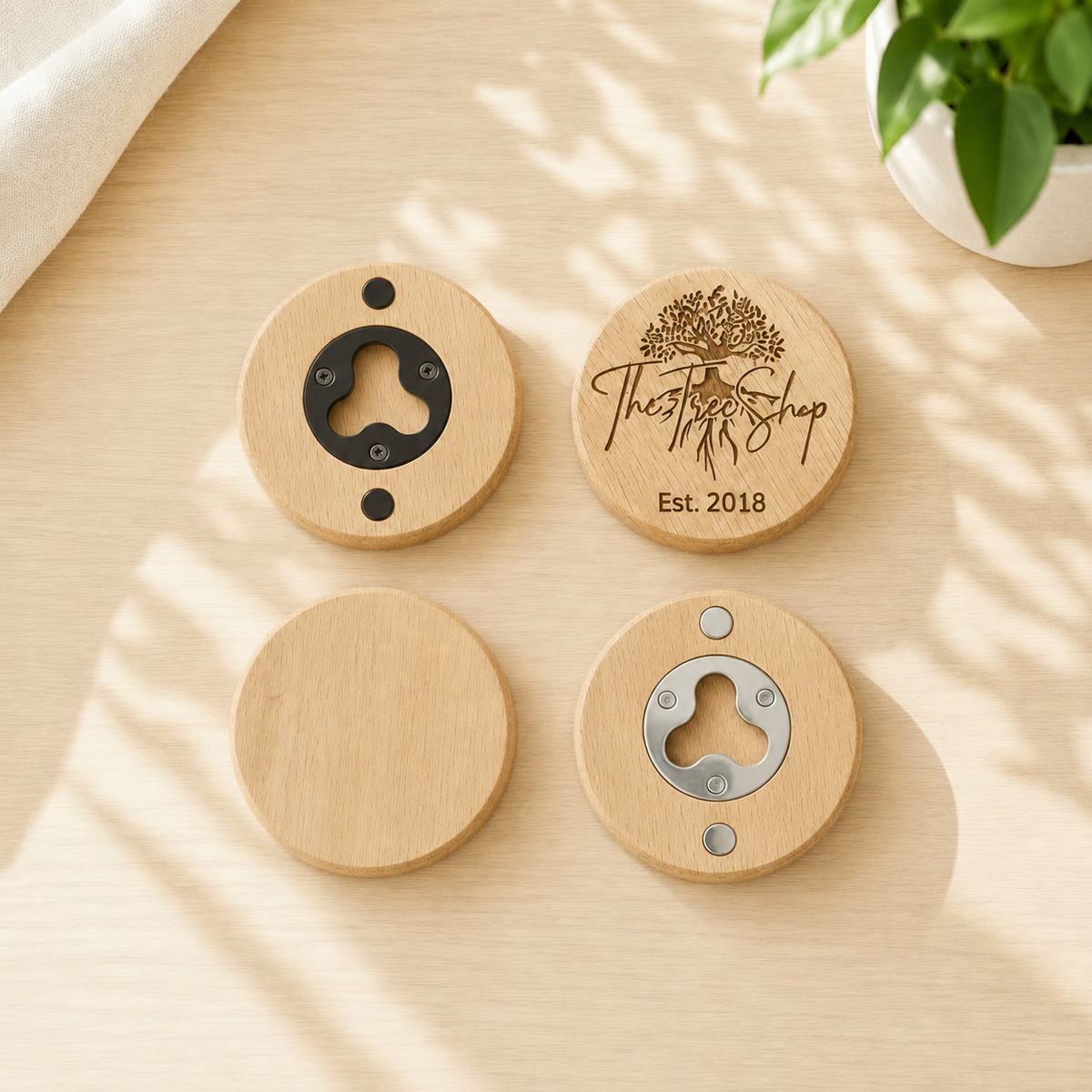 Personalized round wooden bottle openers with black and silver metal inserts on a sunlit wood table