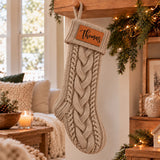 Custom name Christmas stocking in a neutral cable-knit design for a coordinated farmhouse-inspired holiday display.
